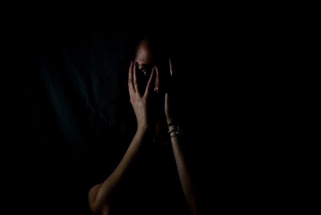 silhouette covering face with hands