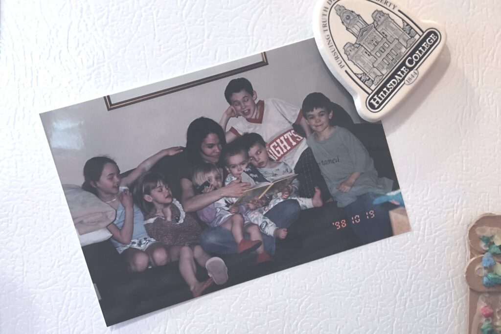 picture of Andrews family from 1998 with children huddled around Missy reading