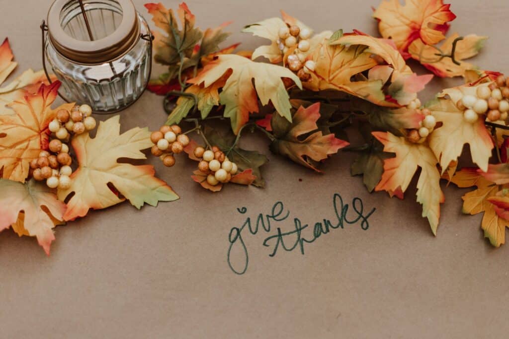 autumnal table setting with "give thanks" written on tablecloth