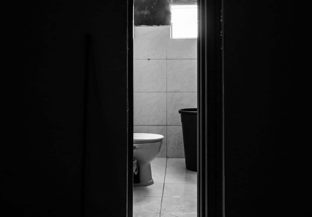 bathroom toilet barely visible through doorway