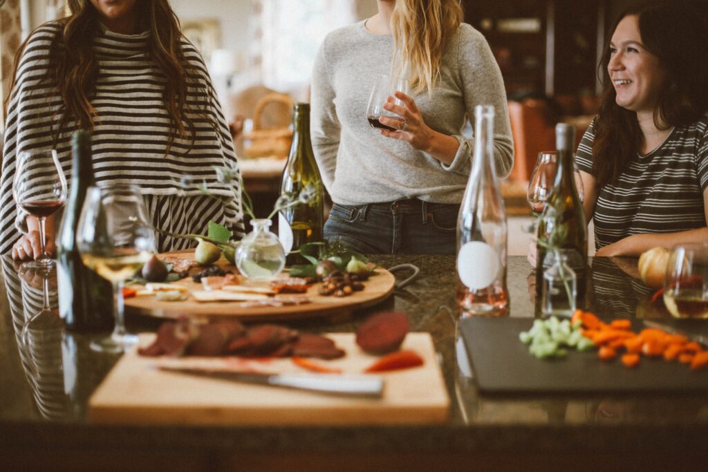 women chatting around a table of appetizers